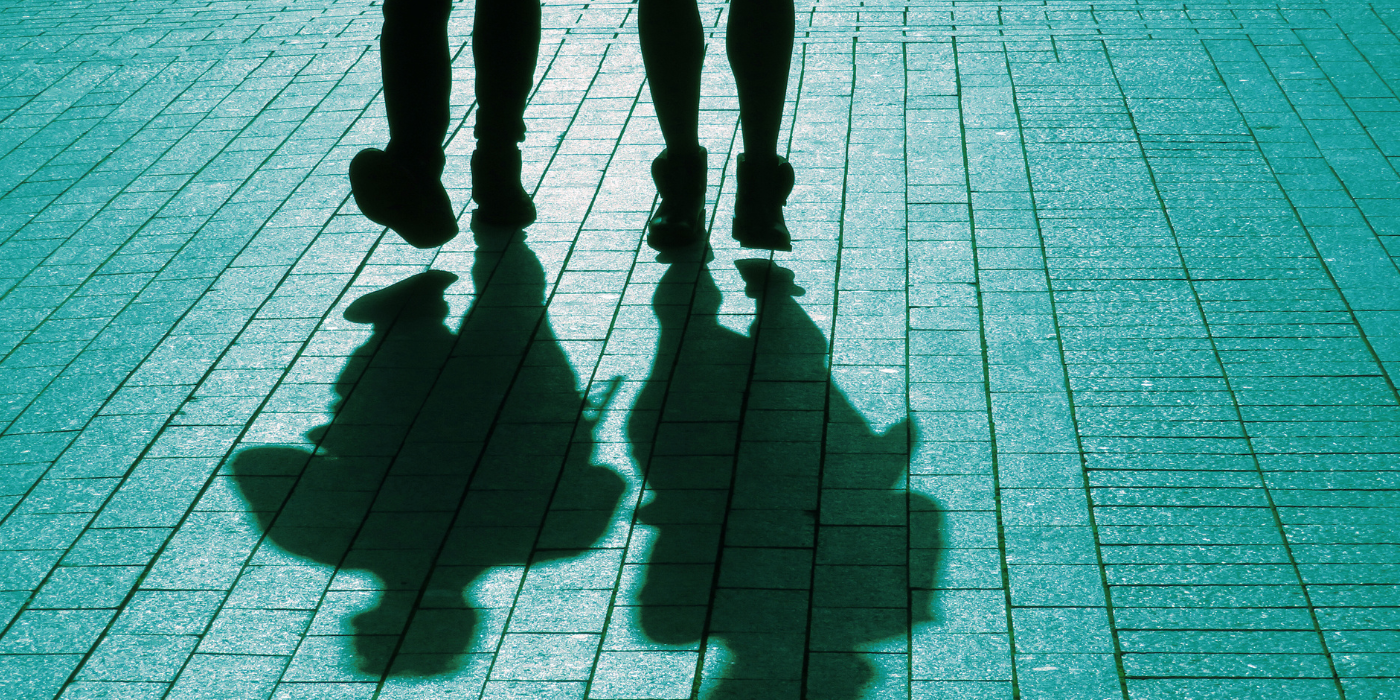 Two people walking side by side to illustrate the customer journey