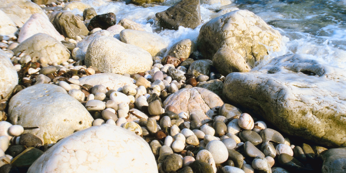 A pebbled beach being washed over by the tide